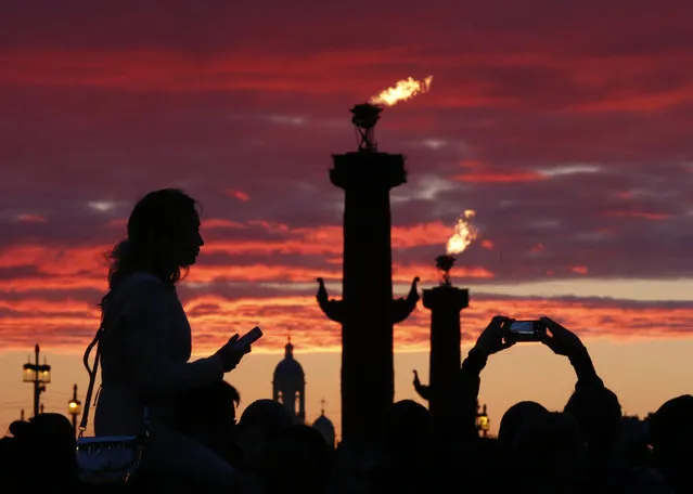 People wait to watch fireworks during the Scarlet Sails festivities marking school graduation, in St. Petersburg, Russia, June 23, 2017. (Photo by Grigory Dukor/Reuters)