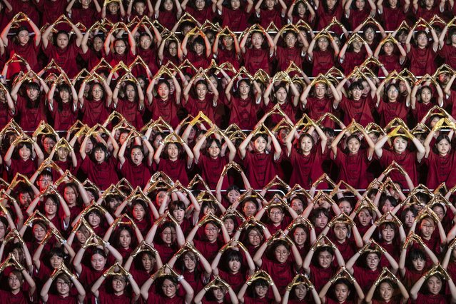 Participants attend the chorus performance as part of the celebration of the national day in Hong Kong, Monday, September 30, 2024. (Photo by Chan Long Hei/AP Photo)