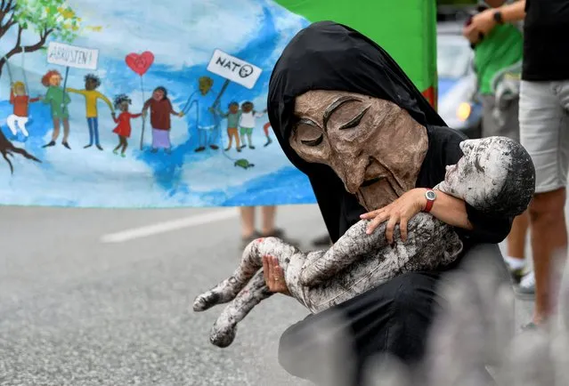 A demonstrator wearing a costume takes part in a protest march, during the G7 leaders' summit which takes place in the nearby Bavarian alpine resort of Schloss Elmau castle, in Garmisch-Partenkirchen, Germany, June 26, 2022. (Photo by Andreas Gebert/Reuters)