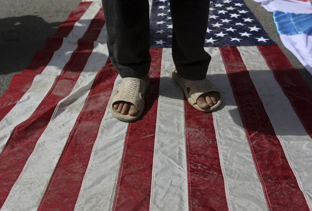 A demonstrator steps on a U.S. flag during a protest against Israel's military action in Gaza, after offering the last Friday prayers of the holy fasting month of Ramadan, in Kabul July 25, 2014. (Photo by Omar Sobhani/Reuters)