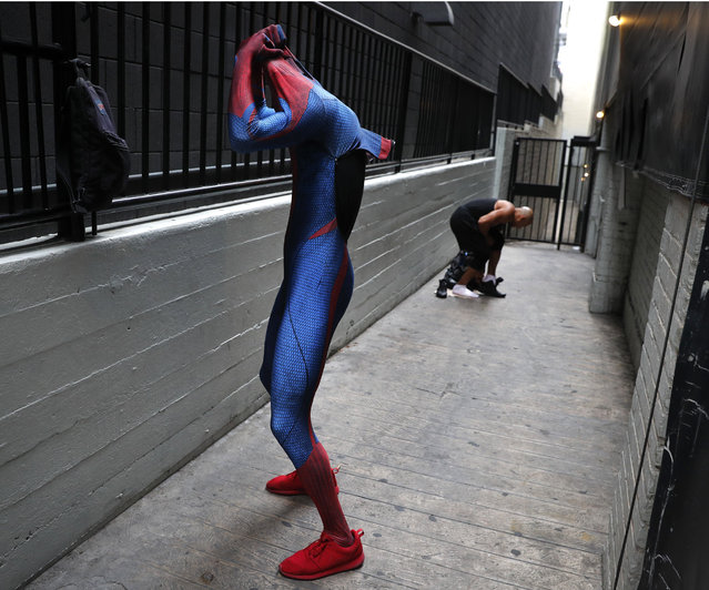 In this Thursday, May 25, 2017 photo, two Spider-Man impersonators, Rashad Rouse, front, and Juan Carlos Banegas, an immigrant from Honduras, change in the alley next to the TCL Chinese Theatre after working on Hollywood Boulevard in Los Angeles. The boulevard is a place of diversity with a cast of superheroes from all over the world including Ukraine, England, Mexico, Germany and Nigeria. (Photo by Jae C. Hong/AP Photo)