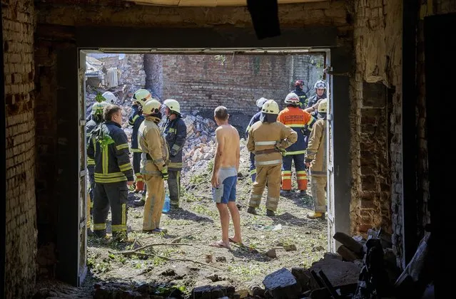 Rescue forces and a local man inspect an area with debris of a building destroyed after a shelling in Kharkiv, Ukraine, 09 July 2022. At least three people were injured during the shelling Sinegubov, the head of the Kharkiv regional administration said. Russian troops on 24 February entered Ukrainian territory, starting a conflict that has provoked destruction and a humanitarian crisis. (Photo by Sergey Kozlov/EPA/EFE/Rex Features/Shutterstock)