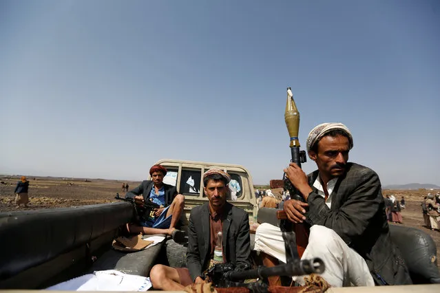 Houthi fighters ride on the back of a patrol truck as they secure the site of a pro-Houthi tribal gathering in a rural area near Sanaa, Yemen July 21, 2016. (Photo by Khaled Abdullah/Reuters)