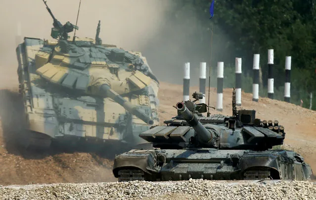 T-72 tanks, operated by crews from Kuwait (front) and Nicaragua, drive during the Tank Biathlon competition, part of the International Army Games 2016, at a range in the settlement of Alabino outside Moscow, Russia, August 2, 2016. (Photo by Maxim Shemetov/Reuters)