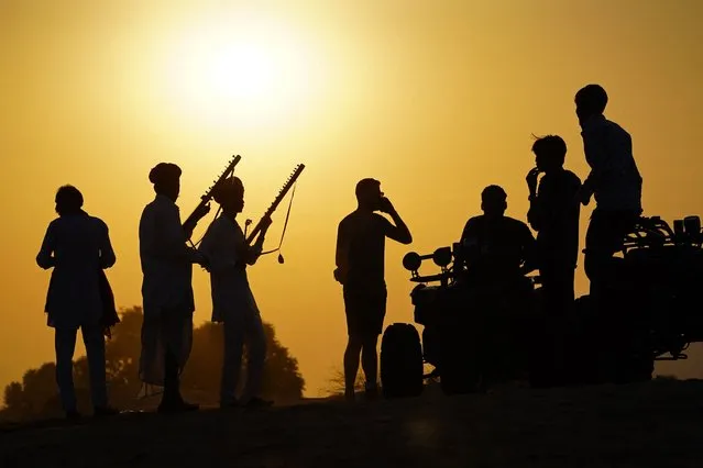 Musicians play traditional instruments for tourists at Pushkar in India's desert state of Rajasthan on October 6, 2022. (Photo by Himanshu Sharma/AFP Photo)