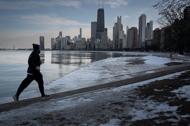 A runner runs along the shore of Lake Michigan as temperatures dipped into the single-digits on February 17, 2025 in Chicago, Illinois. Temperatures are expected to remain below normal in the city for the remainder of the week. (Photo by Scott Olson/Getty Images)