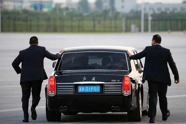 Security agents run alongside the car transporting Egypt's President Abdel Fattah al-Sisi as he arrives at Hangzhou Xiaoshan international airport before the G20 Summit in Hangzhou, Zhejiang province, China September 3, 2016. (Photo by Damir Sagolj/Reuters)