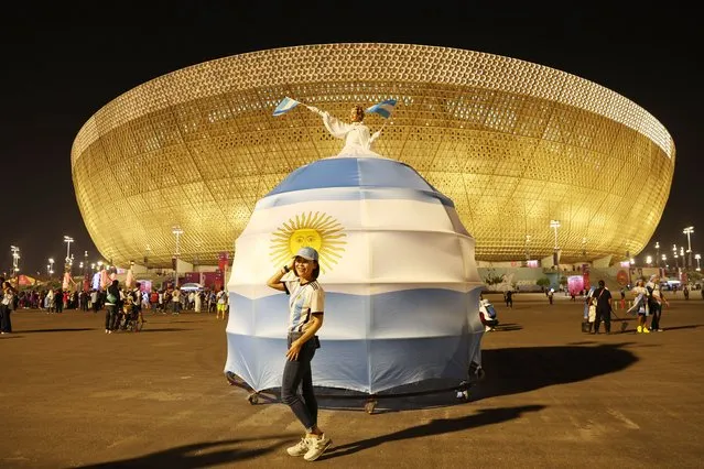 An Argentina fan enjoys the pre match atmosphere outside the stadium prior to the FIFA World Cup Qatar 2022 semi final match between Argentina and Croatia at Lusail Stadium on December 13, 2022 in Lusail City, Qatar. (Photo by Julian Finney/Getty Images)