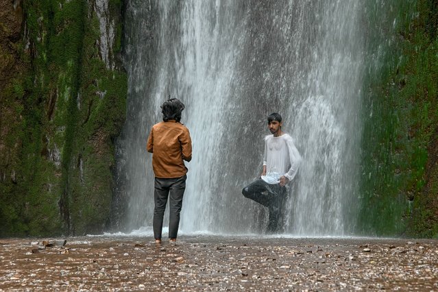 Tourists visit the Dhanni waterfall on the Neelum Valley Road, some 35 kilometres from Muzaffarabad, on May 2, 2025, following the Pakistan and India ongoing border tensions over the Kashmir tourist attack. Nuclear-armed rivals Pakistan and India have exchanged gunfire across their heavily militarised de facto border in contested Kashmir since an April 22 attack that New Delhi blames on Islamabad, a claim it rejects. (Photo by Farooq Naeem/AFP Photo)