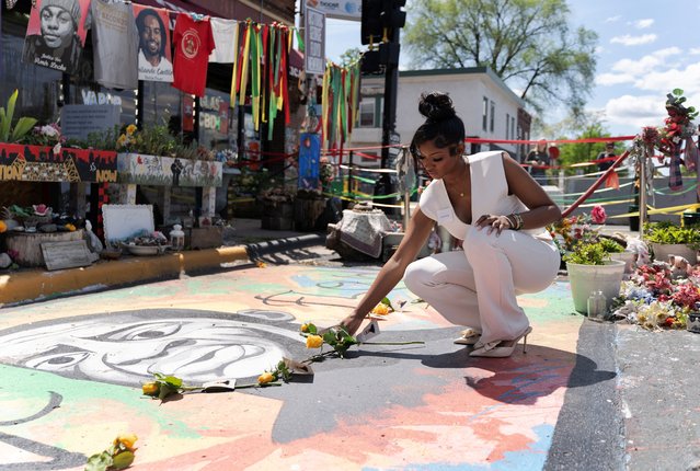 Danielle Miller places a rose on the memorial for George Floyd ahead of the fifth anniversary of his murder by former police officer Derek Chauvin in Minneapolis, Minnesota, on May 23, 2025. (Photo by Lucy Baptiste/Reuters)