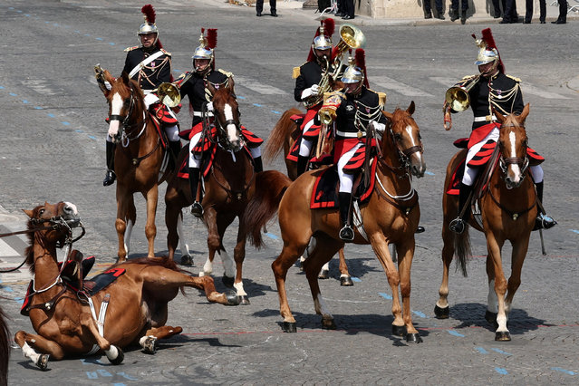 A horse of the French Republican Guard falls during the annual Bastille Day military ceremony on the Champs-Elysees avenue in Paris, France on July 14, 2025. (Photo by Gonzalo Fuentes/Reuters)