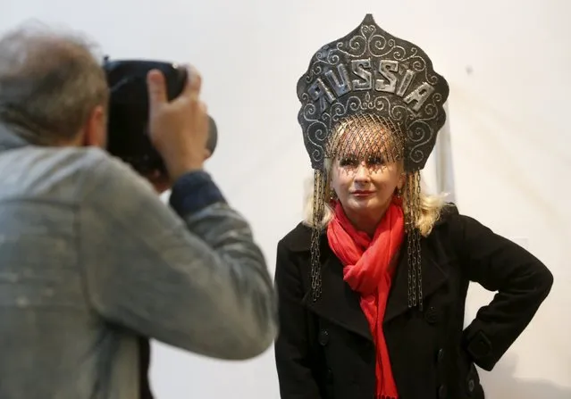 A woman wearing an art object from the project "Imperial Kokoshniks" by Russian artist Vasily Slonov, poses for a photograph during the exhibition "Quilted cavaliers of the apocalypse" at the Winzavod center of contemporary art in Moscow, Russia October 24, 2015. (Photo by Sergei Karpukhin/Reuters)