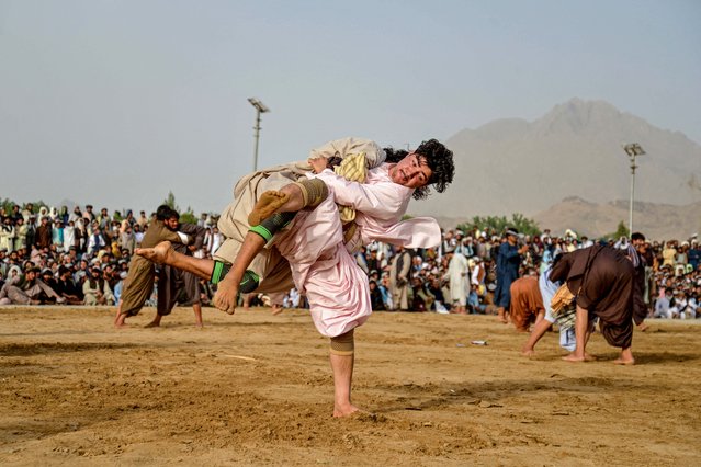 Afghan wrestlers compete during a traditional wrestling competition at a field in Arghandab district of Kandahar province on May 8, 2025. (Photo by Sanaullah Seiam/AFP Photo)