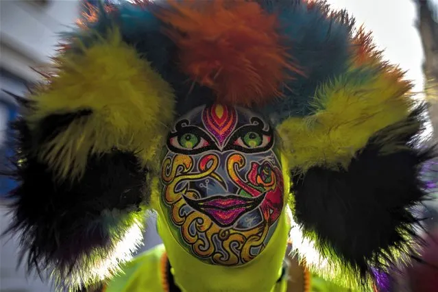 A masked reveler participates in the “Ceu na Terra” Block or Heaven on Earth street party in Rio de Janeiro, Brazil, Saturday, February 11, 2023. From very early in the morning, revelers take to the streets of the bohemian neighborhood of Santa Teresa to celebrate at one of the pre-carnival parties, whose world-famous festivities will officially take place from Feb. 17-25. (Photo byBruna Prado/AP Photo)