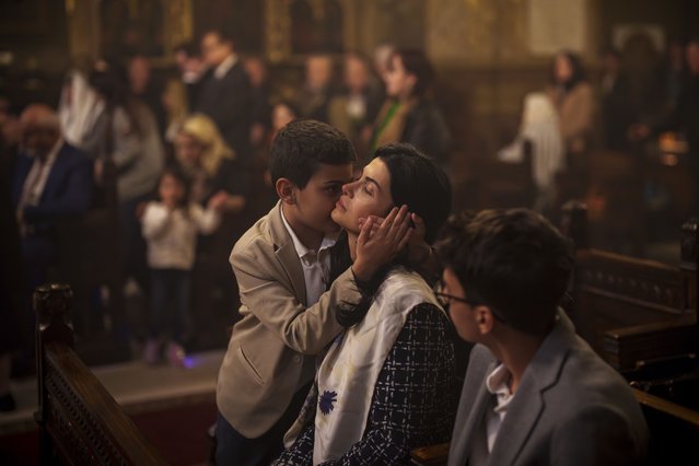 A child hugs a woman as members of the Armenian community attend an Orthodox Easter religious service at the Armenian cathedral in Bucharest, Romania, Saturday, May 4, 2024. (Photo by Vadim Ghirda/AP Photo)