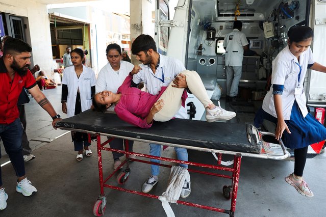 Priyanshi Fakirbhai Patel, 20, who according to medical staff suffers from heat exhaustion, is helped by medical staff at the hospital during a heatwave in Ahmedabad, India, on May 24, 2024. (Photo by Amit Dave/Reuters)