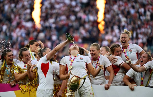 England’s Natasha Hunt pours champagne into the mouth of Zoe Aldcroft as she holds the trophy after England beat Canada 33-13 in the Women’s Rugby World Cup final at Twickenham in London on September 27, 2025. England became world champions on Saturday in front of 81,885 spectators at Twickenham’s Allianz Stadium, while overall 444,465 tickets were sold during the tournament. (Photo by Garry Bowden/ProSport/Rex Features/Shutterstock)