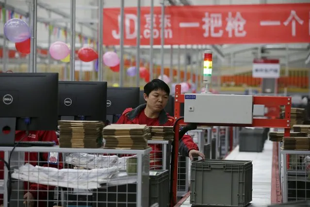 An employee works at a JD.com logistic centre in Langfang, Hebei province, November 10, 2015. (Photo by Jason Lee/Reuters)