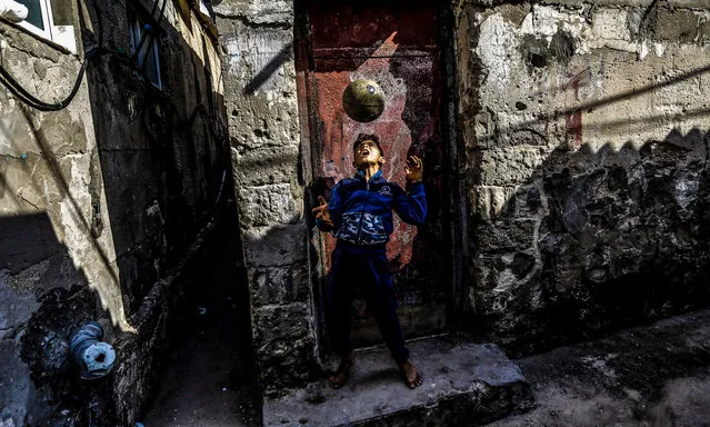 A Palestinian child plays in front of his family's home in the Shati refugee camp in Gaza City, November 9, 2020. (Photo by Mahmoud Issa/Quds Net News via ZUMA Wire/Rex Features/Shutterstock)