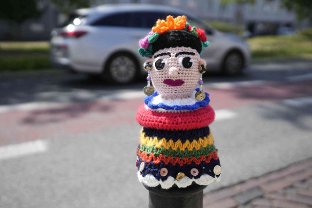 A street bollard is covered by a knitwear mask made by local residents and city activists in Warsaw, Poland, on Wednesday, July 10, 2024. (Photo by Czarek Sokolowski/AP Photo)