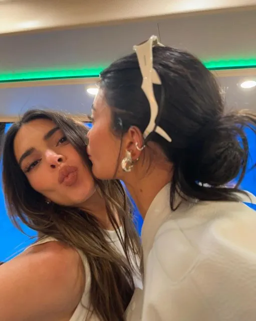 American socialite and media personality Kylie Jenner in the second decade of April 2023 gives her sister, American model, media personality and socialite Kendall, a smooch on the cheek. (Photo by Kylie Jenner/Instagram)