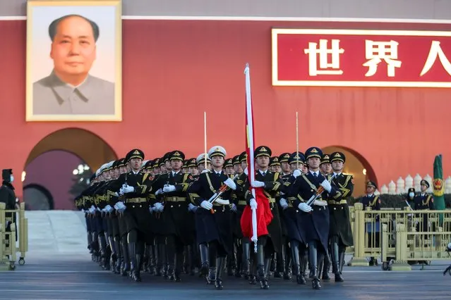Soldiers of the People's Liberation Army (PLA) honor guard escort the national flag from the Forbidden City to Tiananmen Square during the flag-raising ceremony on New Year's Day on January 1, 2021 in Beijing, China. (Photo by VCG/VCG via Getty Images)