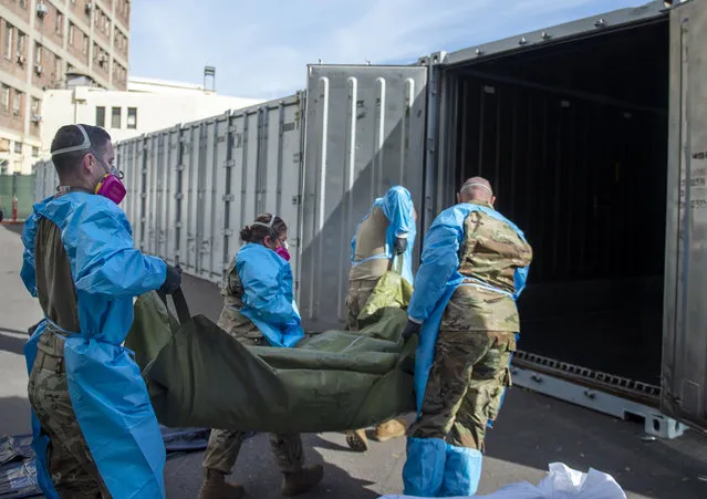 This January 12, 2021, file photo provided by the LA County Dept. of Medical Examiner-Coroner shows National Guard members assisting with processing COVID-19 deaths and placing them into temporary storage at LA County Medical Examiner-Coroner Office in Los Angeles in Los Angeles. More than 500 people are dying each day in California because of the coronavirus. The death toll has prompted state officials to send more refrigerated trailers to local governments to act as makeshift morgues. State officials said Friday they have helped distribute 98 refrigerated trailers to help county coroners store dead bodies. California reported 669 COVID-19 deaths, the second-highest daily death count, on Saturday, Jan. 16, and the nation's most populous county announced it had detected its first case of a more transmissible strain of the coronavirus. Public health authorities in Los Angeles County confirmed its first case of the variant of COVID-19 first detected in the United Kingdom. It was identified in a man who recently spent time in the county. (Photo by LA County Dept. of Medical Examiner-Coroner via AP Photo, File)