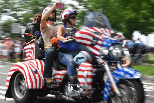 Thousands of bikers and military veterans take part in the Rolling Thunder motorcycle parade in Washington DC, on May 27, 2018. Wearing bandanas, cowboy hats or gleaming helmets, tens of thousands of bikers descended on Washington Sunday to parade in honor of US soldiers missing in action in foreign wars, a now 30-year-old tradition known as “Rolling Thunder”. (Photo by Marvin Joseph/The Washington Post)