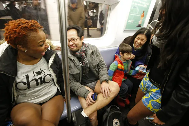 A woman riding the subway with her son laughs after realizing she encountered the annual No Pants Subway Ride, Sunday, January 11, 2015, in New York. The No Pants Subway Ride began in 2002 in New York as a public prank and has since been celebrated by commuters around the world. (Photo by Kathy Willens/AP Photo)