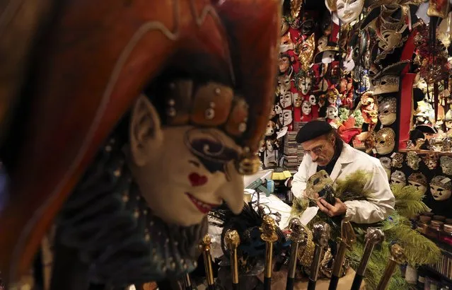 Iranian mask artisan Hamid works on a carnival mask in his shop “Ca' del Sol” near St. Mark's square during the first day of carnival in Venice February 1, 2015. (Photo by Stefano Rellandini/Reuters)