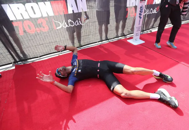Second placed Filipe Azevedo of Portugal reacts after crossing the finish line of the 6th edition of the Ironman 70.3 Dubai 2021 race in G​ulf emirate of Dubai, United Arab Emirates, 12 March 2021. (Photo by Ali Haider/EPA/EFE)