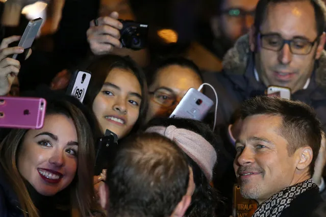 Actor Brad Pitt takes a selfie with fans as he arrives at the premiere of the film “Allied” in Madrid November 22, 2016. (Photo by Juan Medina/Reuters)