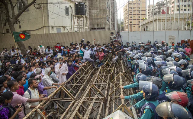 Bangladeshi policemen stand in front of police barricades as Bangladesh eminent citizens and leftist party members attempt to march towards the Prime Minister's office in Dhaka, Bangladesh, 03 March 2021. Protesters are demanding abolition of the Digital Security Act 2018 which they claim is against freedom of expression, as well as justice over the death of writer Mushtaq Ahmed who was detained under digital security law, and immediate release all activists arrested. (Photo by Monirul Alam/EPA/EFE)