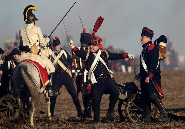 History enthusiasts, dressed as soldiers, fight during the re-enactment of Napoleon's famous battle of Austerlitz near the southern Moravian town of Slavkov u Brna, Czech Republic December 3, 2016. (Photo by David W. Cerny/Reuters)