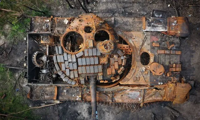A destroyed Russian tank begins to rust in woodland near Kyiv on June 07, 2022 in Kyiv, Ukraine. A sense of normality has increasingly returned to Kyiv as Russia's assault has focused on the eastern Donbas region. (Photo by Christopher Furlong/Getty Images)