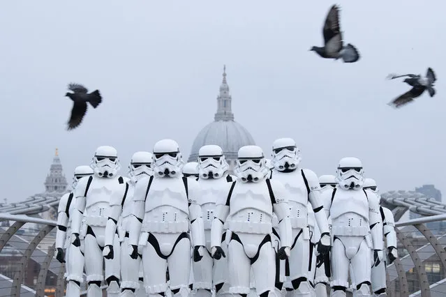 People dressed as Stormtroopers from the Star Wars franchise of films pose on the Millennium Bridge to promote the latest release in the series, “Rogue One”, on December 15, 2016 in London, England. “Rogue One: A Star Wars Story” is the first of three standalone spin-off films and is due for released in the UK today. (Photo by Leon Neal/Getty Images)