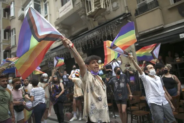 Protesters chants slogans, during a pride event in central Istanbul, Saturday, June 26, 2021. Police used tear gas to disperse the crowds and detained dozens of LGTBI activists as hundreds defied a ban and tried to stage a gay pride event. (Photo by Emrah Gurel/AP Photo)