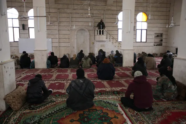 Rebel fighters and people pray in a mosque in al-Rai town, northern Aleppo countryside, Syria December 30, 2016. (Photo by Khalil Ashawi/Reuters)