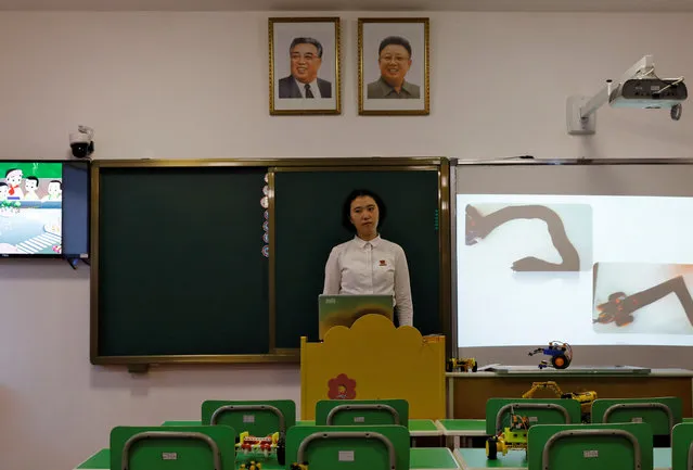 A student stands under the portraits of late North Korean leaders Kim Il Sung and Kim Jong Il during a lecture at a teachers' training college during a government organised visit for foreign reporters in Pyongyang, North Korea, September 7, 2018. (Photo by Danish Siddiqui/Reuters)