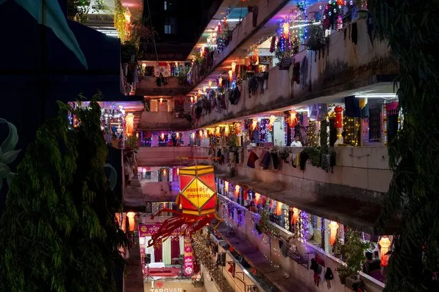 A residential building is decorated with lanterns and lights during Diwali, the festival of lights in Mumbai, India, Sunday, November 12, 2023. (Photo by Rafiq Maqbool/AP Photo)