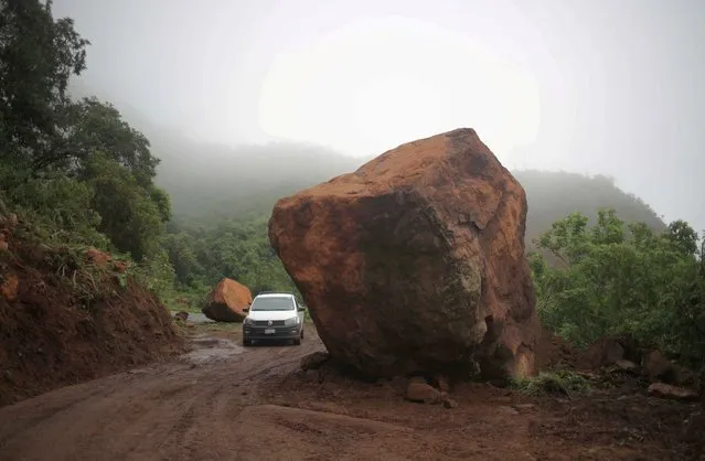 Big stones are pictured blocking a road after an earthquake on Monday, in Ojo de Agua, Michoacan, Mexico on September 20, 2022. (Photo by Henry Romero/Reuters)
