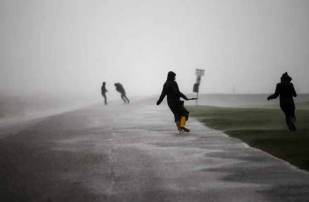 People walk on the North Sea beach near the town of Norddeich, on December 5, 2013. A storm, Xaver, brought strong winds and high tides to the northern coasts of Germany on Thursday. (Photo by Ina Fassbender/Reuters)
