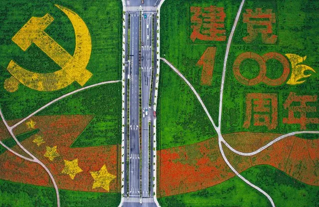 This aerial photo taken on June 28, 2021 shows an image commemorating the 100th anniversary of the Chinese Communist Party formed by flowers in Hangzhou, in China's eastern Zhejiang province. (Photo by AFP Photo/China Stringer Network)