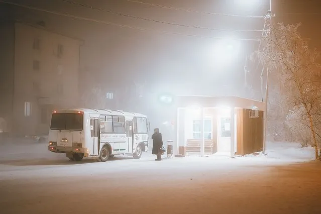 A person is seen waiting for the bus on the street covered with snow and ice as cold weather conditions negatively affect daily life in Yakutsk, the capital of the Sakha Republic eastern Siberia on December 07, 2023. Although people are used to the harsh conditions of winter, the air temperature in Yakutsk drops to minus 30 degrees in the daytime and minus 50 degrees in the night. (Photo by Slava Lyufa/Anadolu via Getty Images)