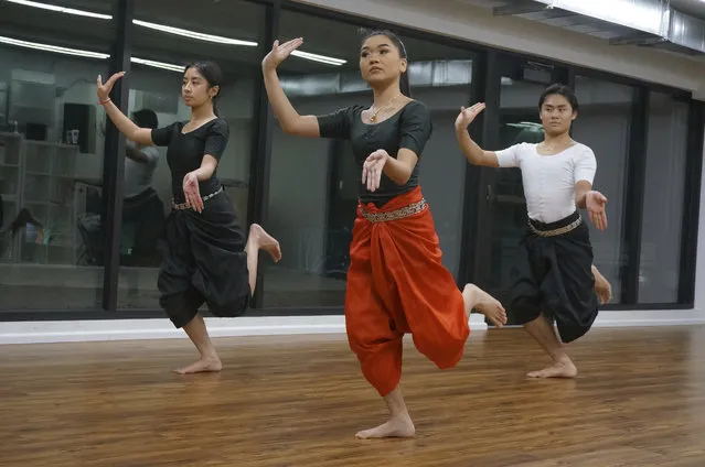 From left, Gabriella Sour, Sabrina Sok and Garrett Sour rehearse traditional, sacred Cambodian dances in the Wattanak Dance Troupe studio on Friday, February 3, 2023, in Minneapolis. Seeking to keep ties to both Buddhism and ancestral culture vibrant for new generations, the troupe, which started in the Buddhist temple of Watt Munisotaram, issued its first open enrollment call this winter. (Photo by Giovanna Dell'Orto/AP Photo)