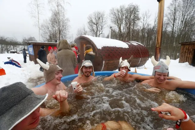 People enjoy open-air hot bath during the sauna marathon near Otepaa, Estonia on February 2, 2019. (Photo by Ints Kalnins/Reuters)