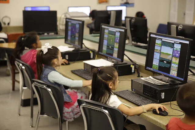 In this Thursday, March 12, 2015 photo, first-graders learn keyboarding skills at Bayview Elementary School in San Pablo, Calif. Schools around the country are teaching students as young as 6, basic typing and other keyboarding skills. (Photo by Eric Risberg/AP Photo)