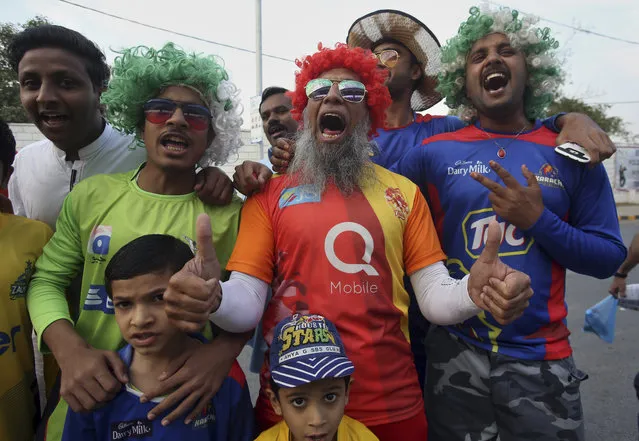 Cricket fans cheers while waiting their turn for security check outside the National Stadium for Pakistan Super League's cricket match in Karachi, Pakistan, Saturday, March 9, 2019. Hundreds of cricket fans proudly displayed their tickets in Karachi as they walked to the National Stadium on Saturday, hours before Pakistan's biggest city hosts the last leg of the Pakistan Super League over the next nine days. (Photo by Fareed Khan/AP Photo)