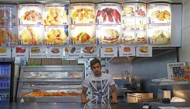 Mohammed Ali, 22, poses for a photograph at his workplace, Jersey Chicken, in the London constituency of Brent Central, Britain, April 3, 2015. Ali, who was born in Pakistan said: “I'm not much interested in politics but my uncle who owns the business is a Labour supporter so I will do the same”. (Photo by Eddie Keogh/Reuters)