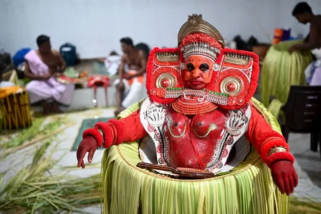 An Indian artist dressed as the Hindu deity Bhagawathy waits to perform during the traditional dance festival “Theyyam” also known as “Kaliyattam”, at Muthappa Swami temple in Somwarpet on March 19, 2024. (Photo by Idrees Mohammed/AFP Photo)